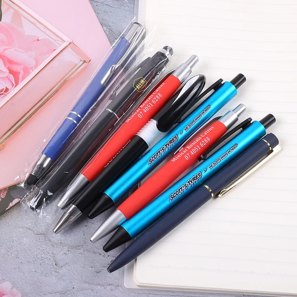 Collection of branded advertising pens in blue, red, black, turquoise and silver-colored finishes