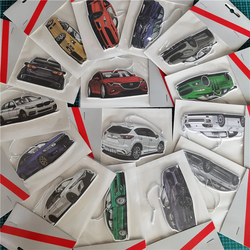 Assorted car-shaped paper air fresheners displayed in individual transparent retail bags