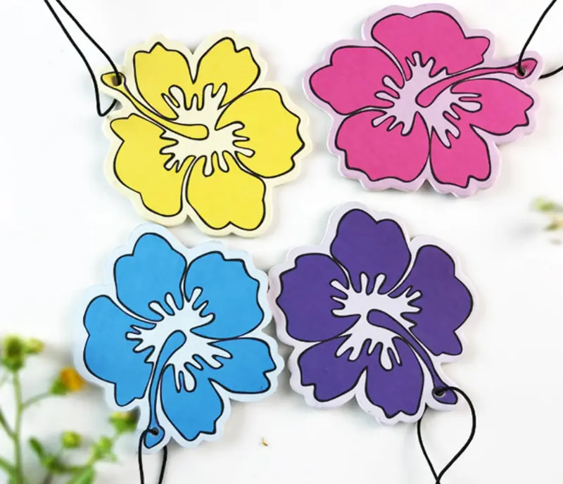 Four colorful hibiscus flower-shaped paper air fresheners with black hanging cords