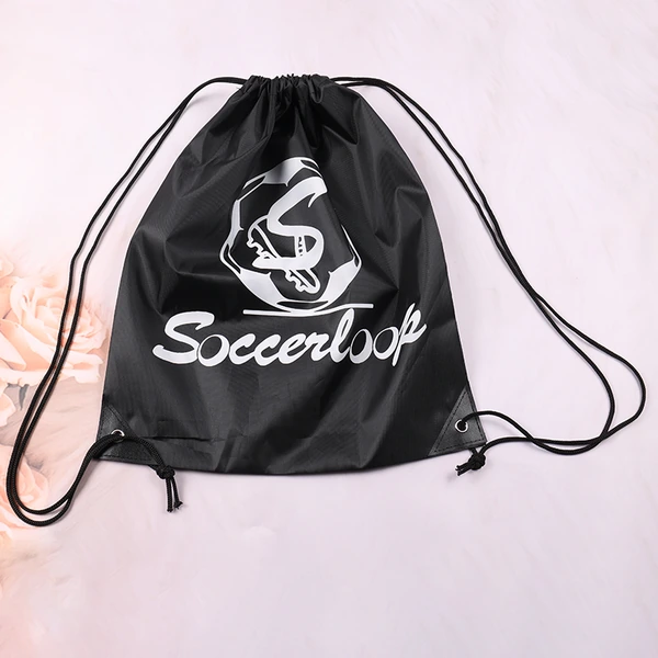 Black drawstring bag laid flat with white logo printing and long black cords