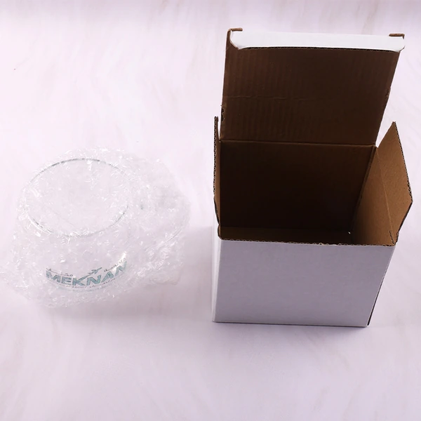 Clear glass mug beside an open white carton with brown interior