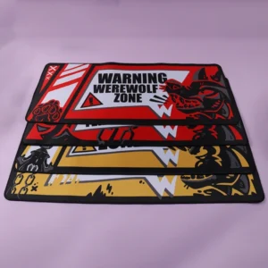 Three rectangular desk mats showing red werewolf, red feline and yellow big cat designs