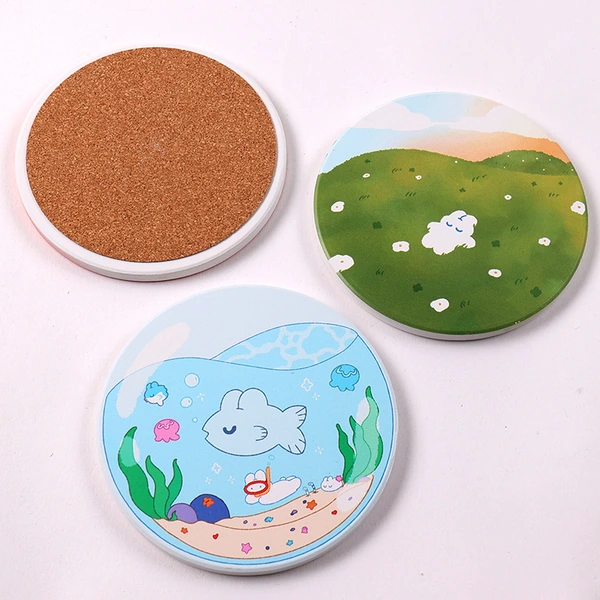 Round illustrated coasters showing printed faces and a brown cork backing