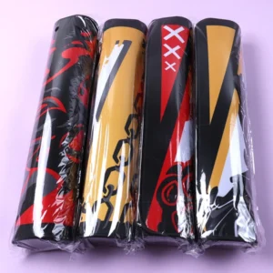 Rolled printed desk mats in black, red and yellow designs individually wrapped in clear packaging
