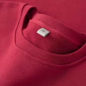 Close-up of a red sweatshirt with a ribbed crew neckline and a white neck label