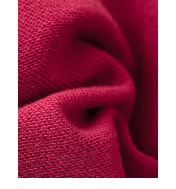 Close-up of folded red fabric showing the textured loopback surface